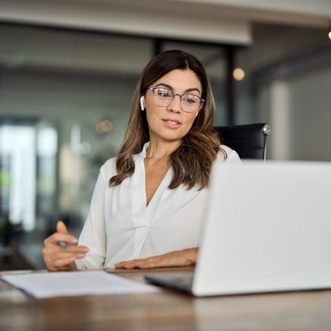 Mid,Aged,Business,Woman,Having,Hybrid,Meeting,Working,In,Office.